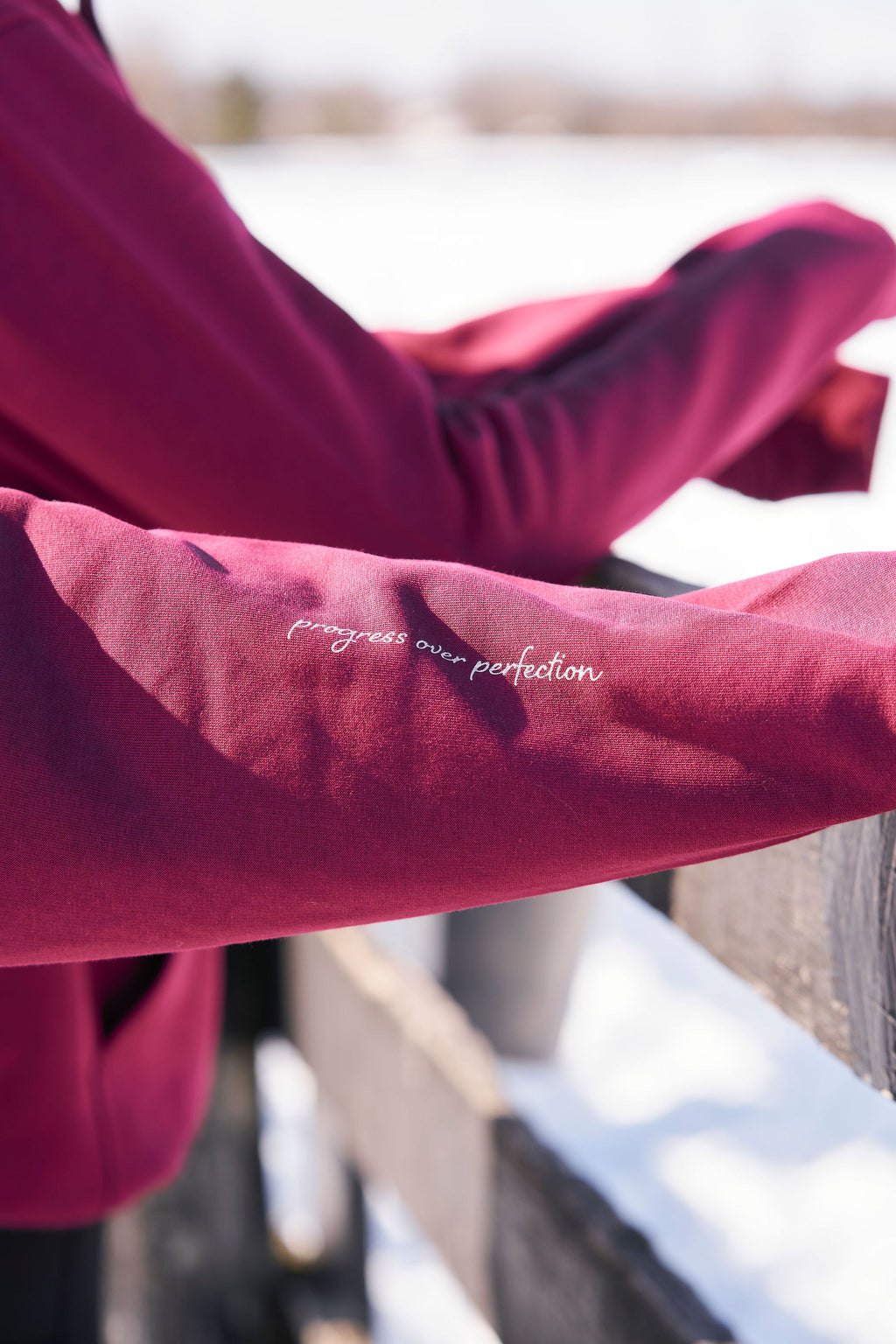 Close-up of a red hoodie in an equestrian setting.